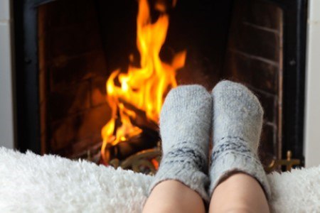 Feet by fireplace